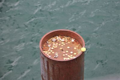 High angle view of coffee cup on shore