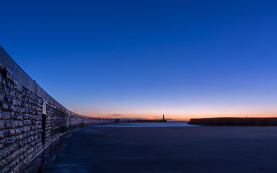 Bridge against clear blue sky during sunset