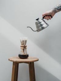 Low angle view of person hand on glass table