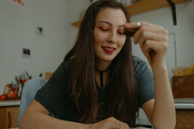 Young beautiful woman with the smartphone at home