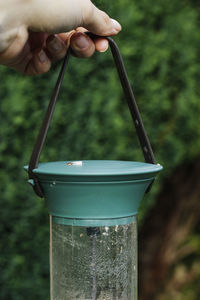 Woman's holding bird seed feeder.
garden wild bird feeder