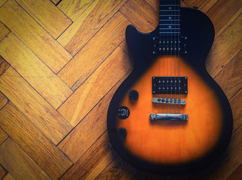 Directly above shot of guitar on parquet floor