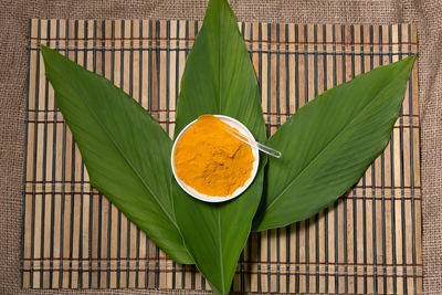 Close-up of orange leaves on green leaf