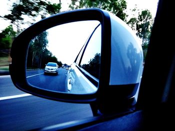 Reflection of car on side-view mirror