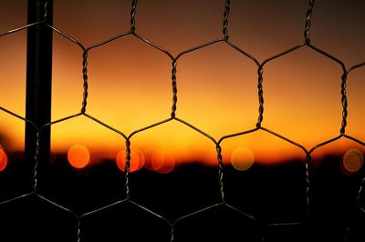 Close-up of soccer field against sunset sky