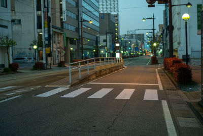 Street amidst buildings at night