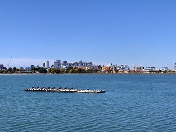 South boston waterfront and shipping containers at the commercial port against clear blue sky