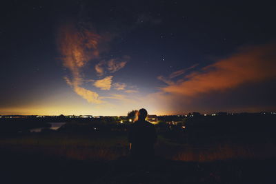 Silhouette man standing against sky during sunset