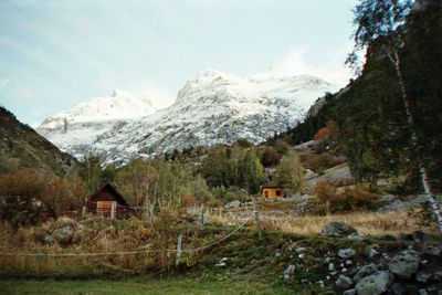 Scenic view of snow covered mountains against sky