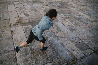High angle view of boy walking on footpath