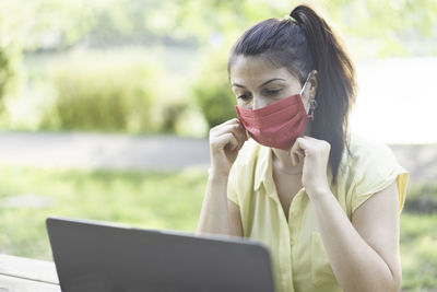 Young woman using mobile phone outdoors