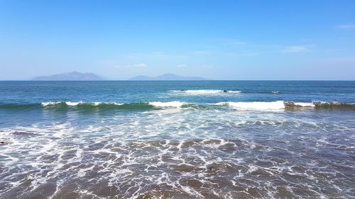 Scenic view of sea against blue sky