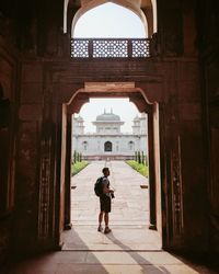 Rear view of woman walking in historic building