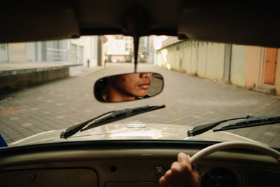 Young man in car on street