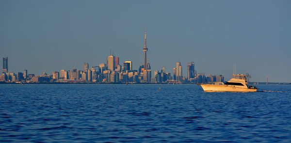 Ship in sea with city in background