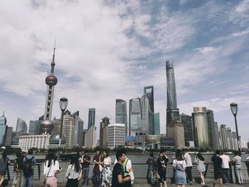 View of skyscrapers in city against cloudy sky