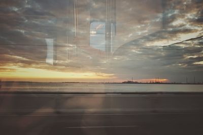 View of suspension bridge against cloudy sky