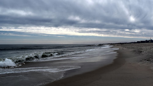 View of beach against cloudy sky