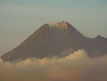 View of volcanic mountain against cloudy sky