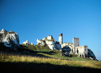 Low angle view of castle against clear blue sky