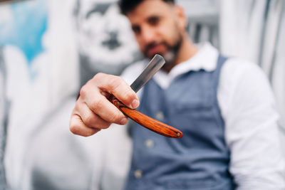 Midsection of man holding ice cream