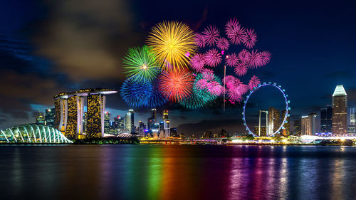 Firework display over city at night