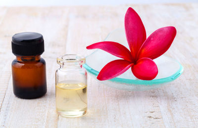 Close-up of essential oils and flower on table