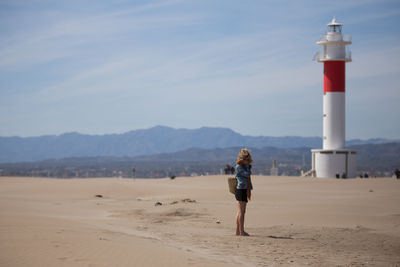 Full length of woman on beach against sky