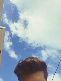 Low angle portrait of woman against sky