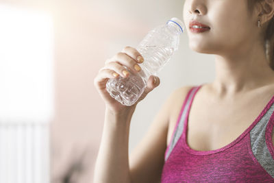 Midsection of woman drinking glass