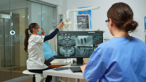 Dentists examining medical x ray at clinic