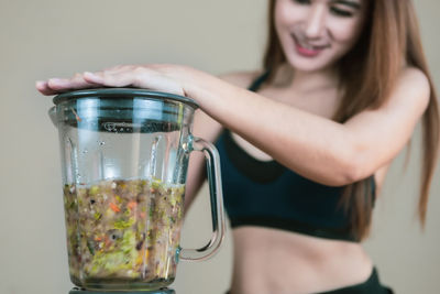 Woman holding glass of drink
