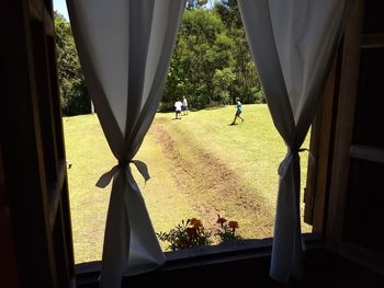 Rear view of people standing on golf course