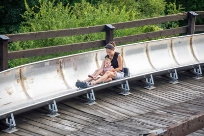 Woman sitting on railing