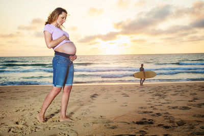 Full length of woman standing at beach