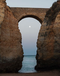 Arch in sea against sky