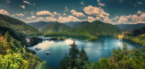 Scenic view of lake and mountains against sky