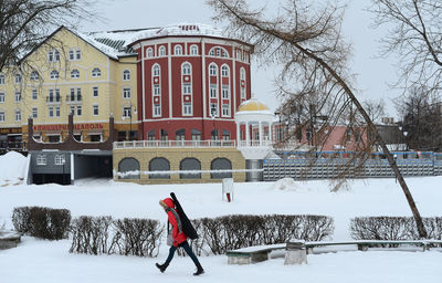 Man standing on snow covered city in winter