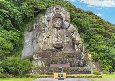 Giant buddha daibutsu of nihonji temple on the mountain sides of mount nokogiri stone quarry.