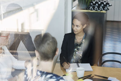 Business man and women discussing in board room