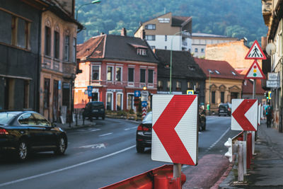 Brasov, romania, 29th of july 2022 - street signs with buildings and cars