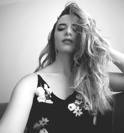 Close-up portrait of beautiful young woman against white background