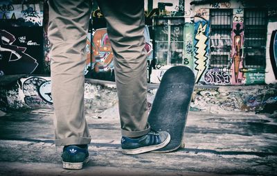 Low section of man standing on floor in city