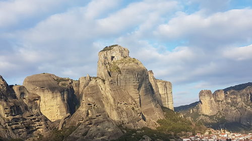 View of rock formations against cloudy sky