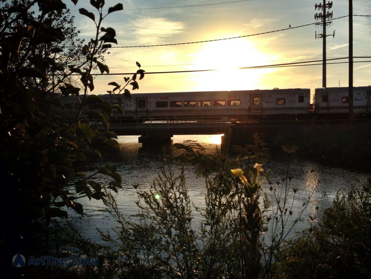 sunset, sky, power line, water, connection, built structure, cloud - sky, electricity pylon, reflection, architecture, tree, cable, river, bridge - man made structure, nature, electricity, building exterior, transportation, no people, outdoors