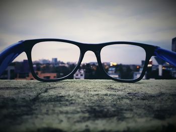 Close-up of sunglasses against sky