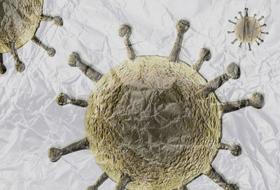 3d-illustration of colorful isolated corona virus covered by plastic film on a white background.