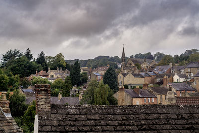 Buildings in town against sky