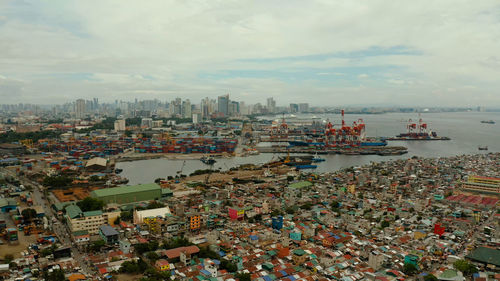 Manila city with port, skyscrapers, modern buildings and makati business center aerial drone. t