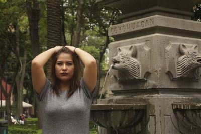 Portrait of young woman statue against building